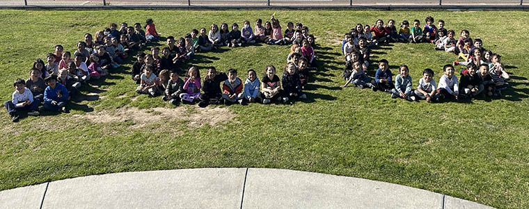 students sitting in formation for 100 days