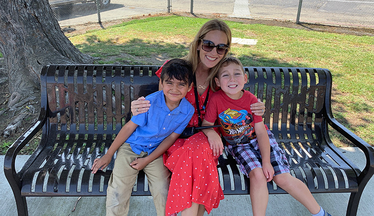 principal and kids on bench