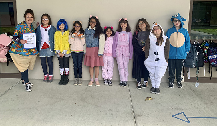 Kids and teacher dressed up as book characters