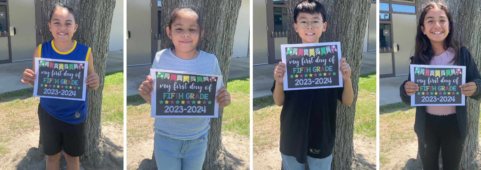 students with first day of 5th grade signs